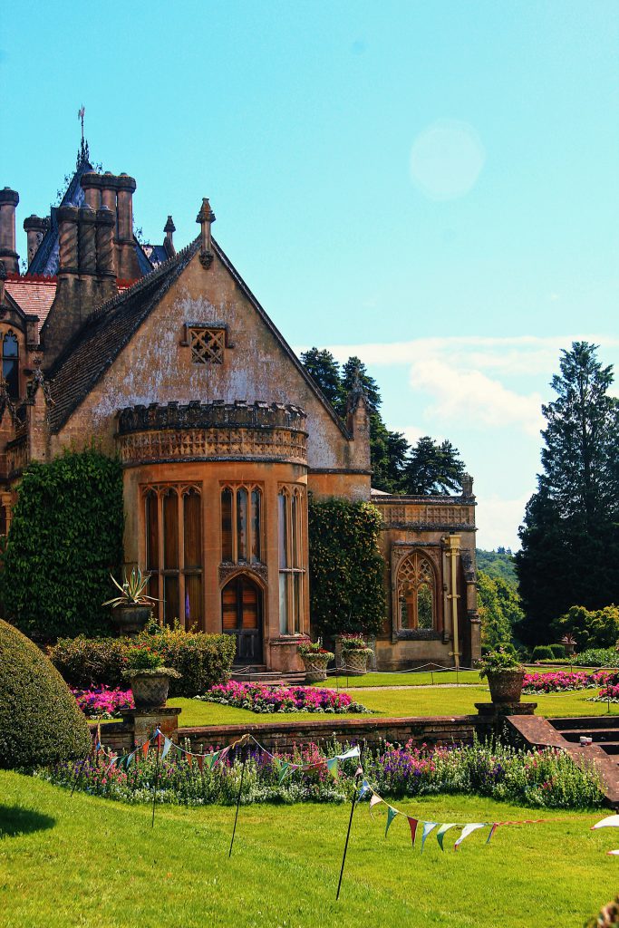 Tyntesfield National Trust Park and gardens, Bristol, UK. Gothic Church in the background with blue sky on a sunny day and festive decorations around