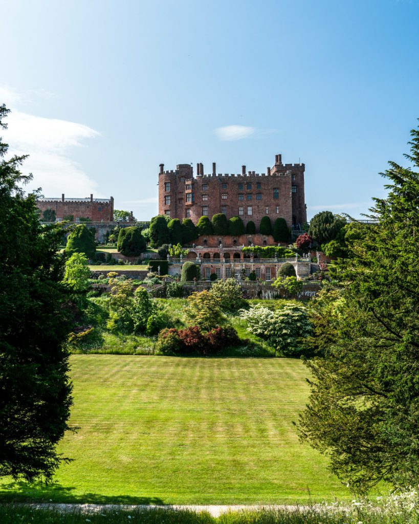 Powis Castle, Welshpool, UK. Castle in the background with green lawn in foreground